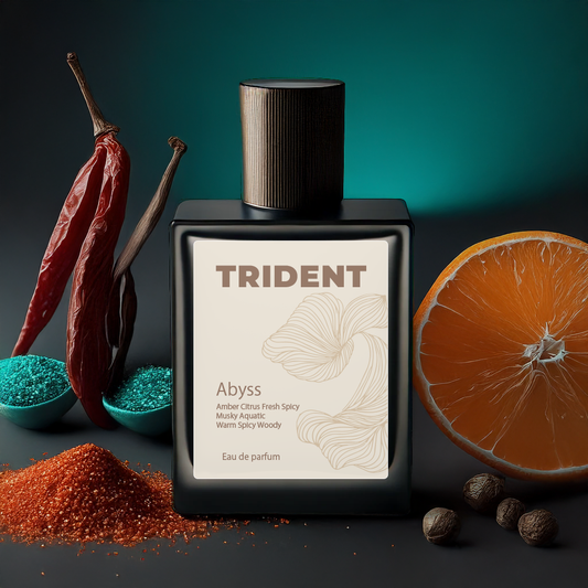 Trident Abyss eau de parfum bottle with spices and an orange on a dark background