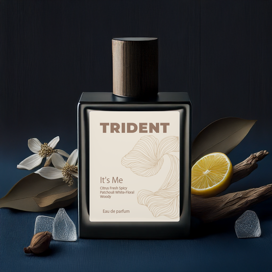 Trident perfume bottle with floral and lemon elements on a dark background