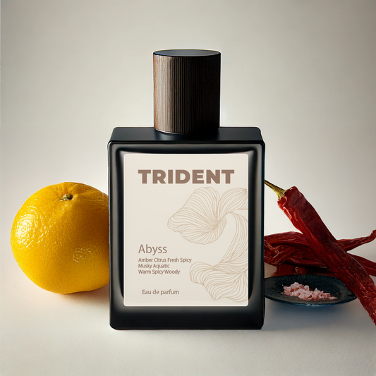 Trident Abyss eau de parfum bottle with an orange, chili pepper, and flower on a neutral background