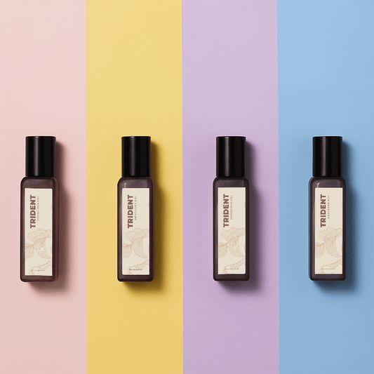 Four 20 ml bottles of Trident perfumes on a multicolored background